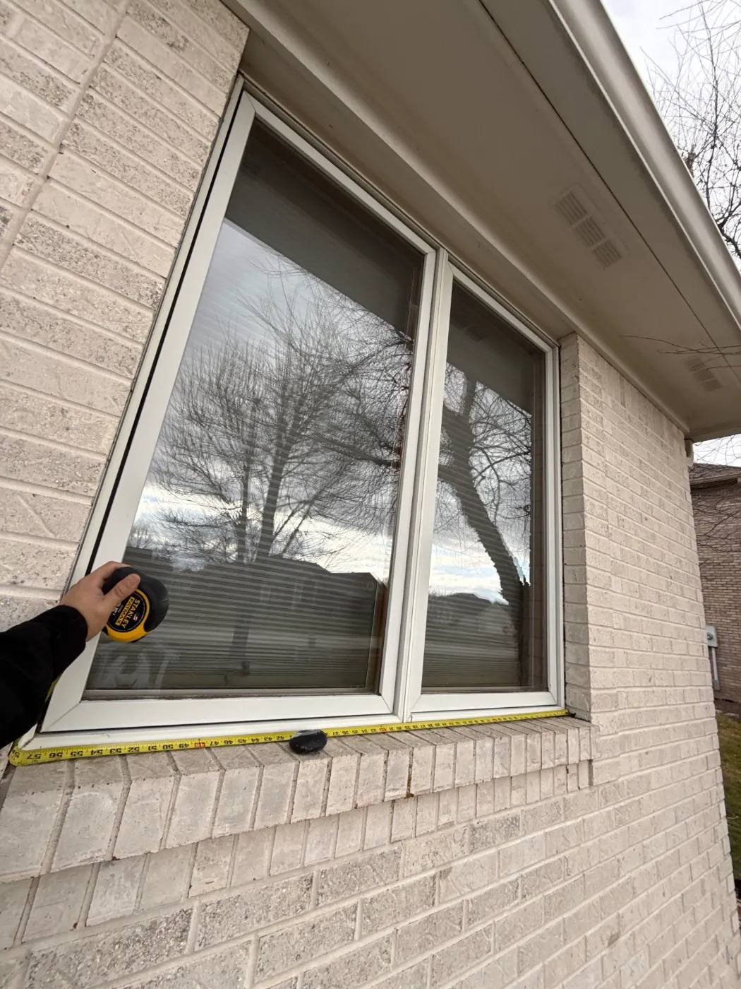 Window replacement documented in Sandstone